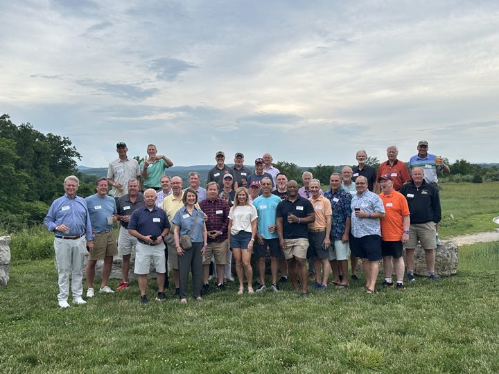 About thirty brothers and guests with name tags on a lawn above the Blacksburg hills, June 2025