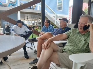 Brothers in chairs on a beach-house porch