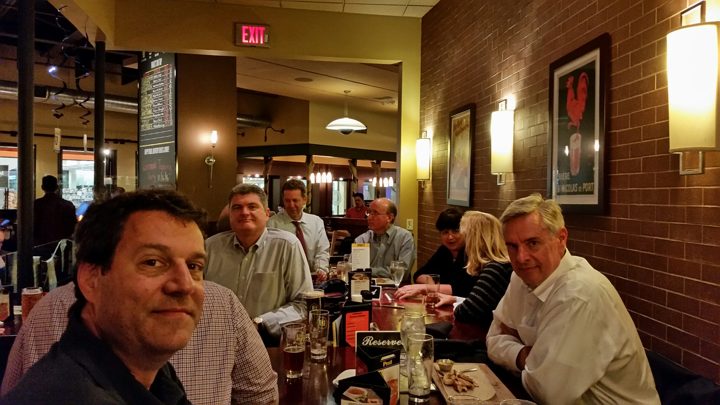 Brothers and guests around a long table in a brewery